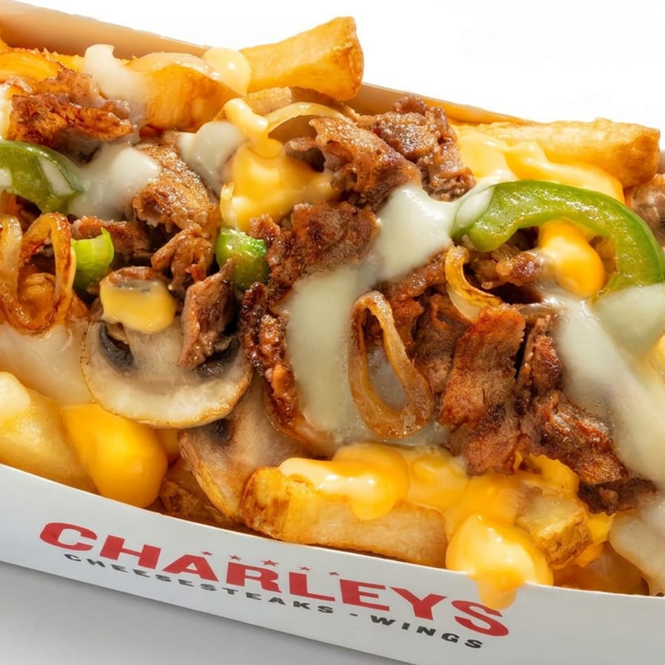 Loaded Charleys cheesesteaks fries topped with sliced steak, mushrooms, peppers, onions, and melted cheese.